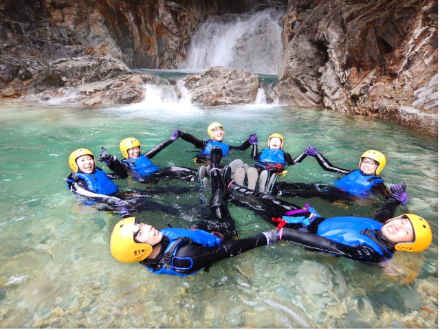 Floating on water with a life jacket.